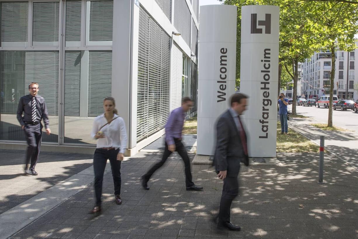 The new logo of LafargeHolcim on panels in front of the head quarters in Zurich, Switzerland, on Wednesday, 15 July 2015. LafargeHolcim today officially launched the new Group around the world and announced key elements of its ambitions for the future. (KEYSTONE/Patrick B. Kraemer)