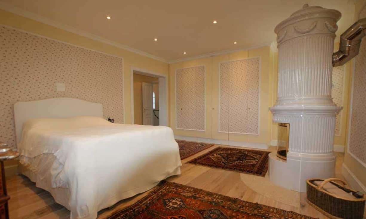 Im Erdgeschoss befindet sich weiter ein grosses Schlafzimmer mit Bad. Die restlichen drei Schlafzimmer befinden sich im ersten Stockwerk. Der Balkon umrundet die Südseite des Gebäudes und ist von den Zimmern her erreichbar.