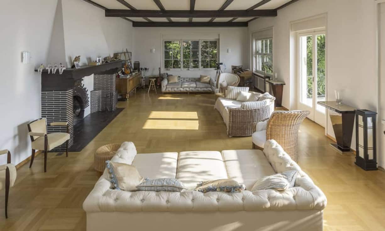 Das schlichte Wohnzimmer verfügt über einen Parkettboden und Balken an der Decke. Der Höhepunkt dieses Raumes ist jedoch…