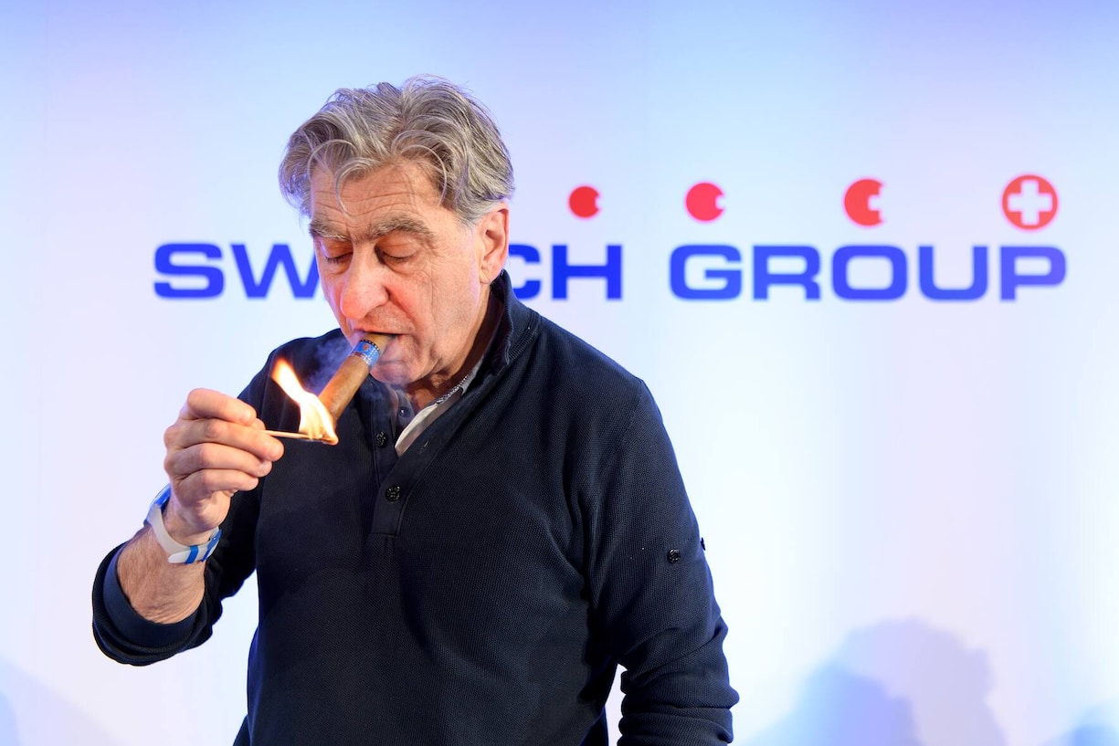 Nick Hayek, CEO Swatch Group, President of the Swatch Group Executive Management Board lights his cigar during a press conference of the year 2017 final results of Swiss watch company Swatch Group, in Biel, Switzerland, this Wednesday, March 14, 2018. (KEYSTONE/Anthony Anex)