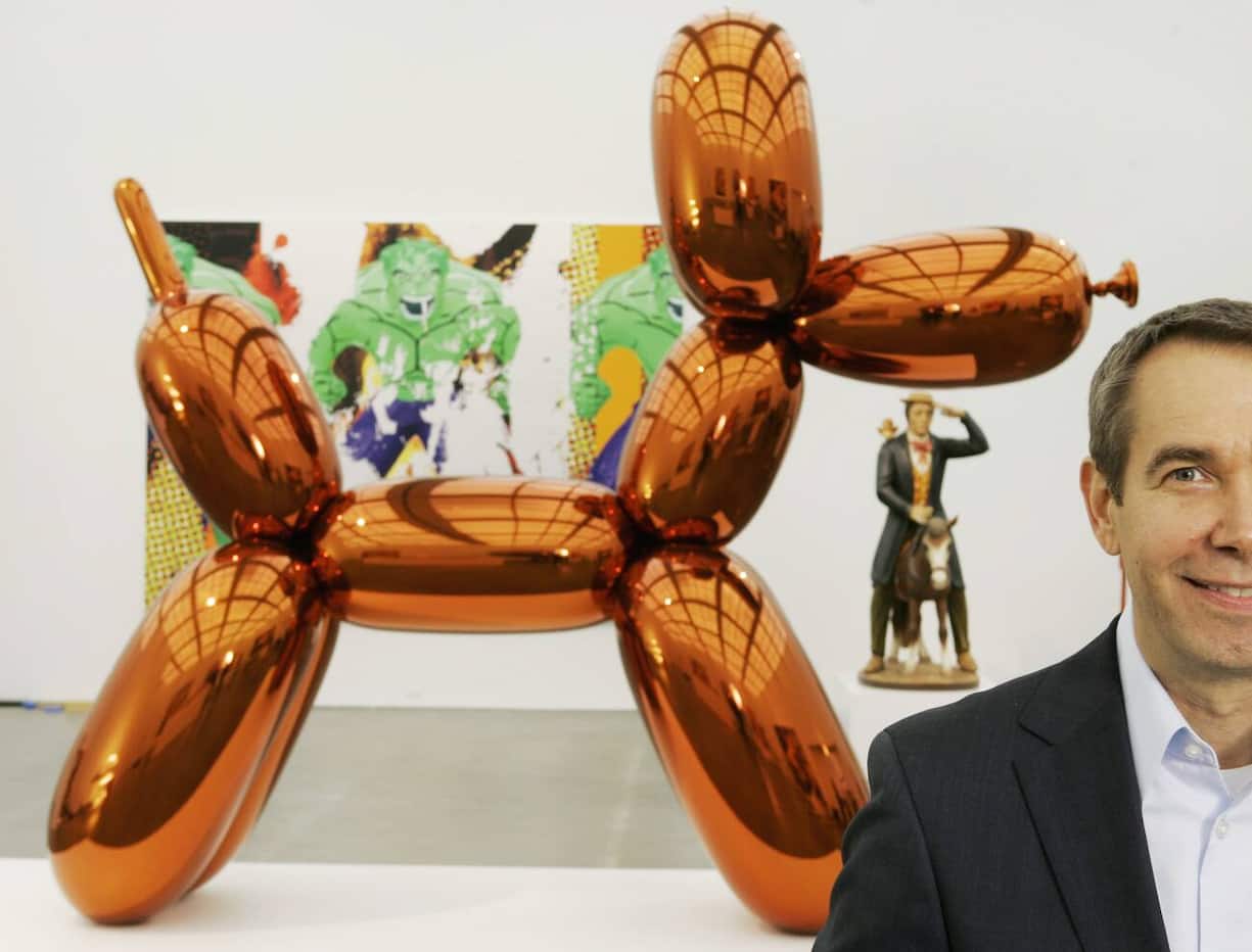 FILE - In this Thursday, May 29, 2008 file photo, artist Jeff Koons poses beside one of his works, "Balloon Dog," on display at Chicago's Museum of Contemporary Art. The more than 10-foot-high chromium stainless steel sculpture of a balloon-animal dog has an orange metallic coating and is part of an exhibit of about 60 other sculptures and paintings by Koons. (AP Photo/Charles Rex Arbogast)