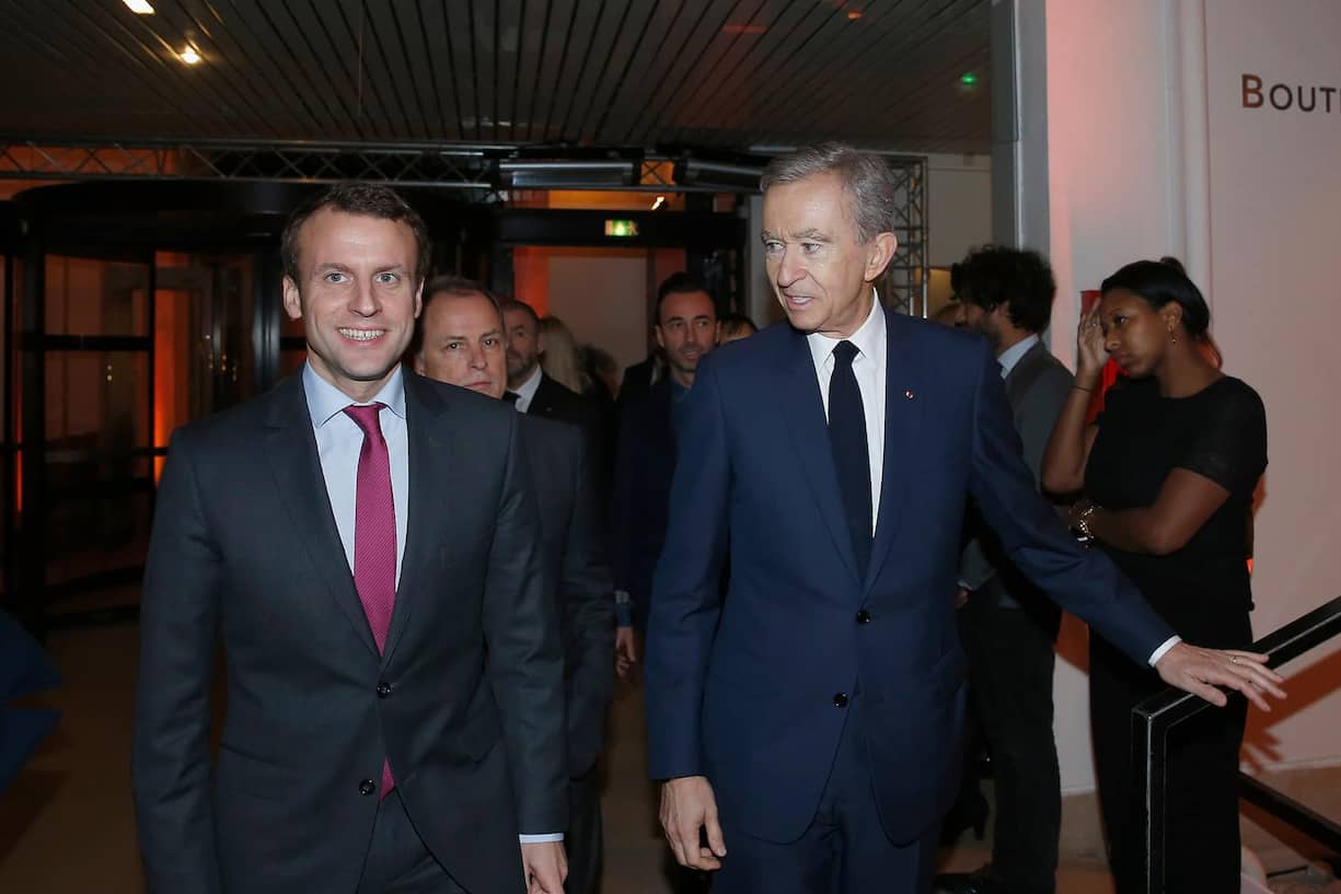 PARIS, FRANCE - DECEMBER 03: Emmanuel Macron and Bernard Arnault arrive at the 'Volez, Voguez, Voyagez - Louis Vuitton' Exhibition Opening  at Le Grand Palais on December 3, 2015 in Paris, France.  (Photo by Rindoff/Le Segretain/Getty Images for Louis Vuitton)