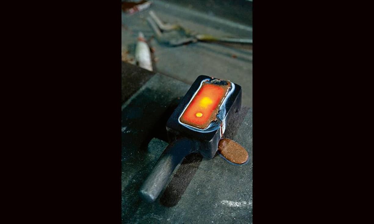 Damit der Barren beim Erkalten eine gleichmässige Oberfläche erhält, muss die Form beim Eingiessen heiss sein.