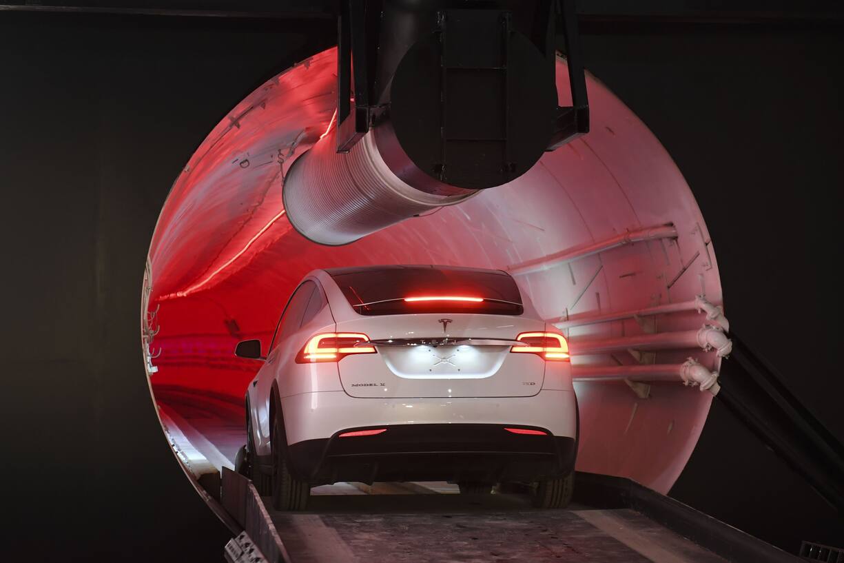 A modified Tesla Inc. Model X drives into the tunnel entrance at an unveiling event for the Boring Co. Hawthorne test tunnel in Hawthorne, California, U.S., on Tuesday, Dec. 18, 2018. Elon MuskÂ took the wraps off hisÂ BoringÂ Co.'s first completed test tunnel on Tuesday, with a lot of razzle-dazzle, the admission he had spent $40 million of his own money on the project and a surprise twist in the underlying technology. Photographer: Robyn Beck/Pool via Bloomberg via Bloomberg