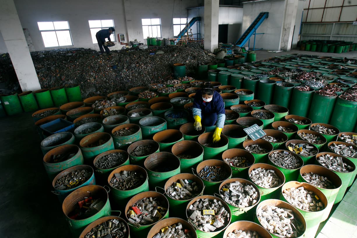 Workers sort batteries in an electronic waste recycling factory in Jingmen, Hubei province December 3, 2009. VCP (Photo by Jie Zhao/Corbis via Getty Images)