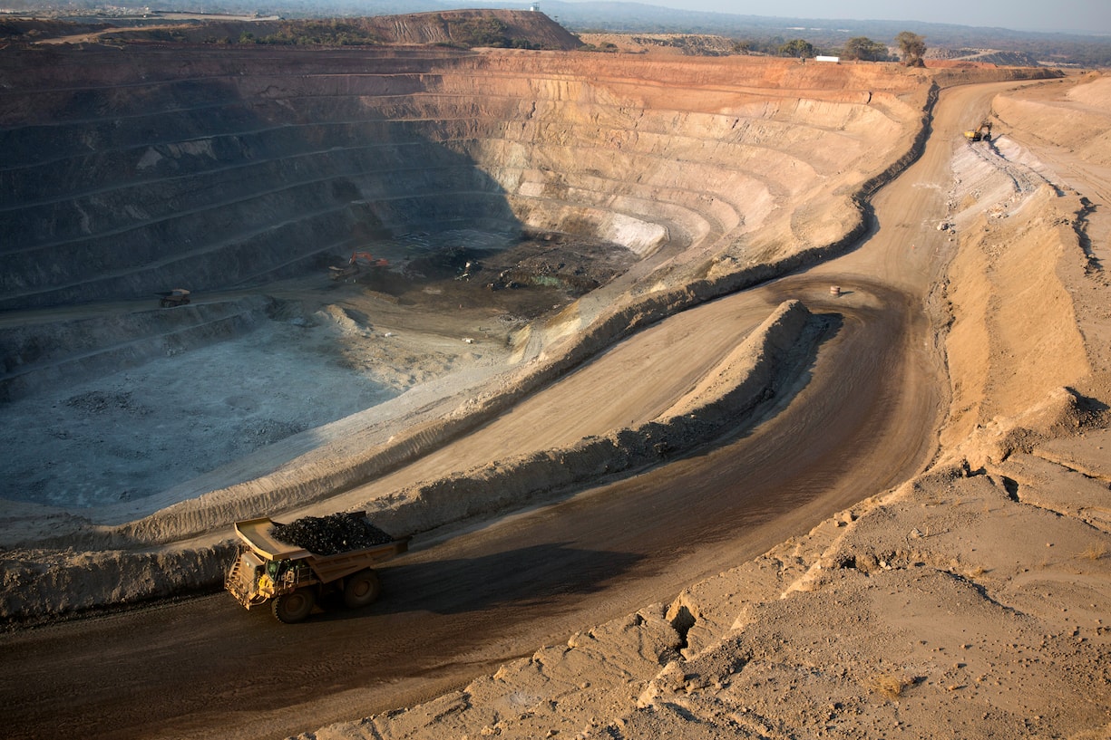 KOLWEZI, DRC- JULY 7: The sun sets on one of the open pit copper mines at Mutanda Mining Sarl on July 6, 2016 in Kolwezi, DRC. The mine is owned (69%) by Glencore, an Anglo-Swiss multinational commodity trading and mining company. The mine is mainly producing copper but also some cobalt. The mine employs about 3,500 people and its located in Luabala Province in Southern DRC. A truck carries a load of ore to the processing plant. (Photo by Per-Anders Pettersson/Getty Images)