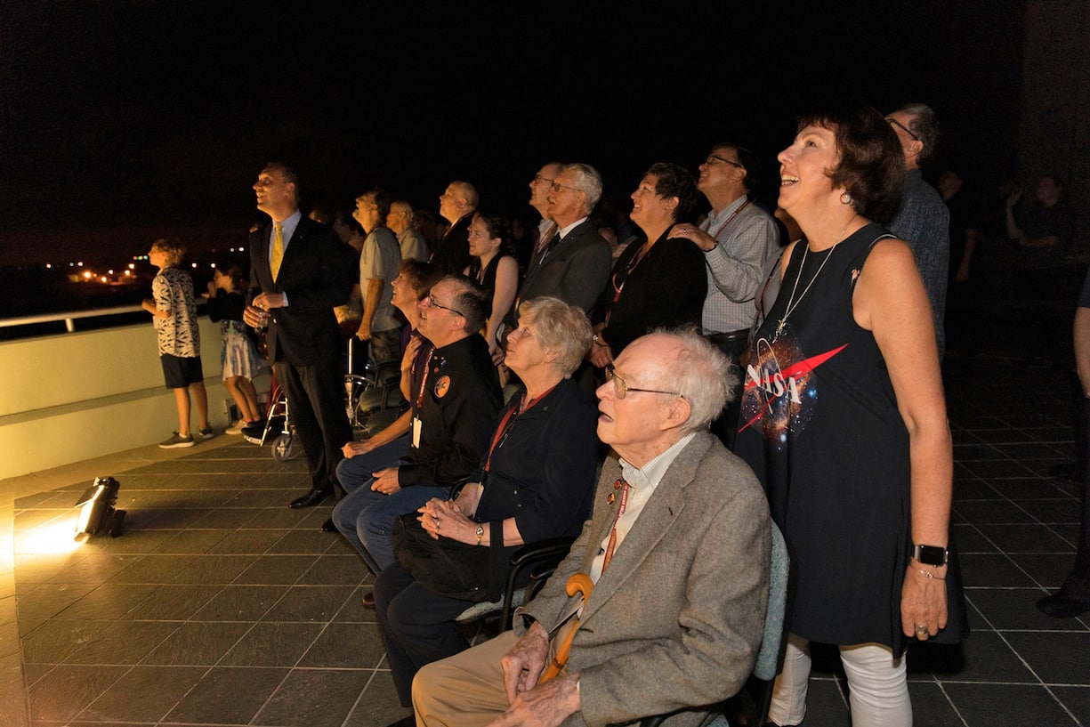 Dr. Eugene Parker (seated in the foreground), a pioneer in heliophysics and S. Chandrasekhar distinguished service professor emeritus for the Department of Astronomy and Astrophysics at the University of Chicago, watches the launch of NASA's Parker Solar Probe. This is the first agency mission named for a living person. Standing behind Parker is Nicky Fox, Parker Solar Probe project scientist at Johns Hopkins Applied Physics Laboratory. 