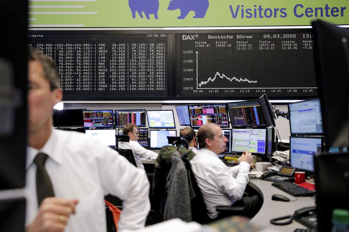 Traders monitor financial data near the DAX Index curve inside the Frankfurt Stock Exchange, operated by Deutsche Boerse AG, in Frankfurt, Germany, on Monday, March 9, 2020. Germanys DAX is set to enter a bear market amid drastic coronavirus containment measures in Italy and a crash in oil markets. Photographer: Alex Kraus/Bloomberg