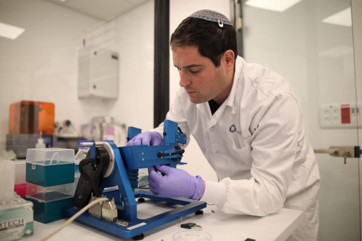 Director of Research Yair Glick adjusts a 'Lab-on-a-Chip' onto a device that simulates microgravity, in the SpacePharma facilities in Herzliya near Tel Aviv, March 04, 2019.