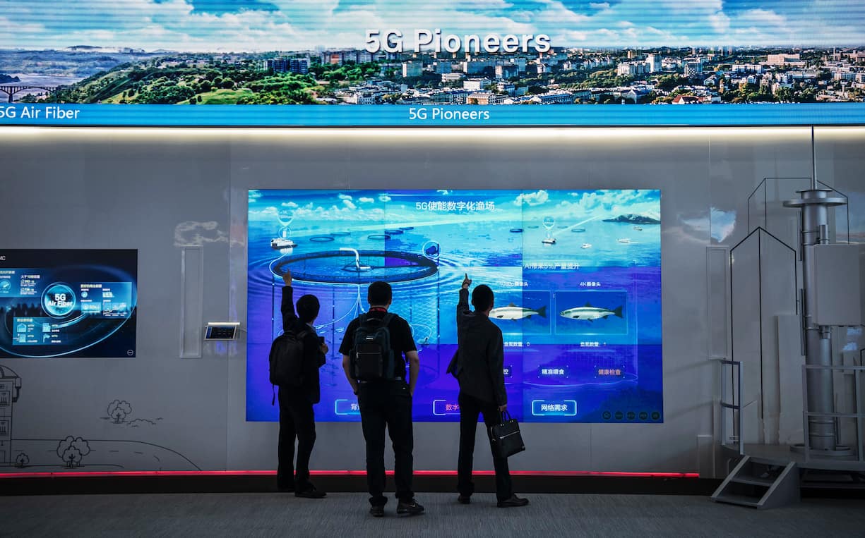 CHINA - APRIL 26: Customers look at a display showing Huawei 5G technology at the company's Bantian campus on April 26, 2019 in Shenzhen, China.