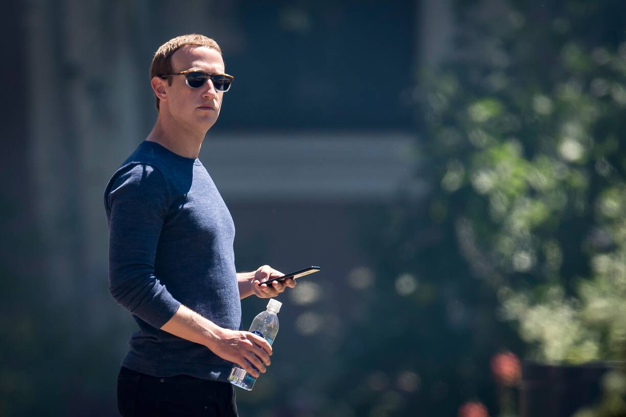Mark Zuckerberg, chief executive officer and founder of Facebook Inc., holds his phone after the morning session at the Allen & Co. Media and Technology Conference in Sun Valley, Idaho, U.S., on Friday, July 13, 2018. The 35th annual Allen & Co. conference gathers many of America's wealthiest and most powerful people in media, technology, and sports. Photographer: David Paul Morris/Bloomberg