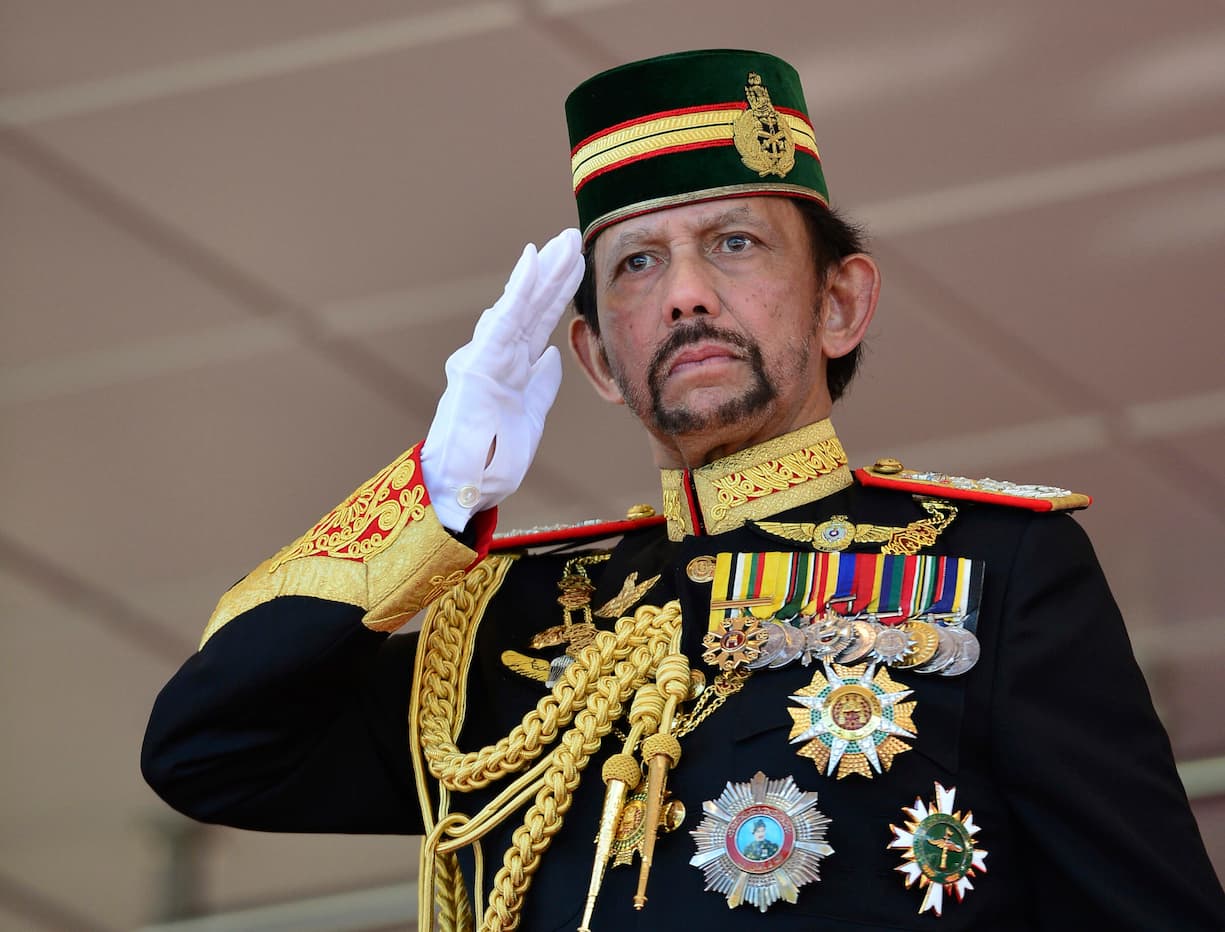 Brunei's Sultan Hassanal Bolkiah dressed in full military regalia salutes to an honor guard during his 73rd birthday celebrations in Bandar Seri Begawan, Brunei, Monday, July 15, 2019. (AP Photo/Ahim Rani)