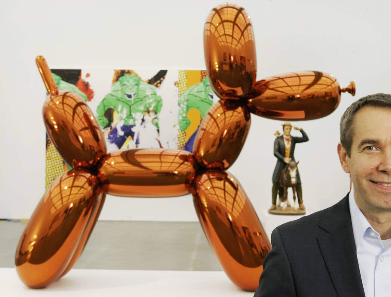 FILE - In this Thursday, May 29, 2008 file photo, artist Jeff Koons poses beside one of his works, "Balloon Dog," on display at Chicago's Museum of Contemporary Art. The more than 10-foot-high chromium stainless steel sculpture of a balloon-animal dog has an orange metallic coating and is part of an exhibit of about 60 other sculptures and paintings by Koons. (AP Photo/Charles Rex Arbogast)
