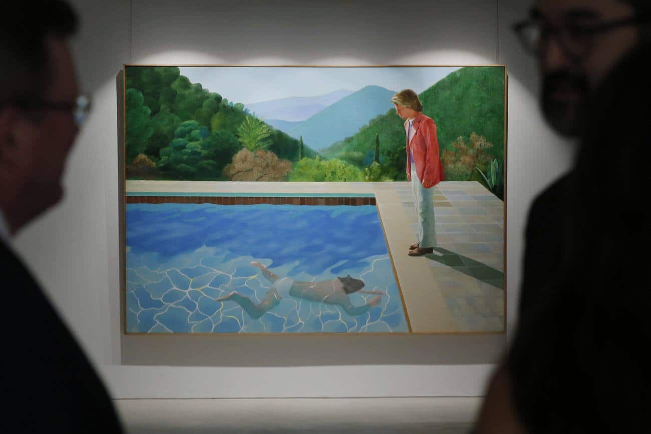 Visitors watch the painting "Portrait of an artist (pool with two figures)" by David Hockney during a media preview by the Christie's auction house in Hong Kong Thursday, Sept. 27, 2018. The painting is expected to fetch US$80 million at the Christie's New York evening sale in November. (AP Photo/Kin Cheung)