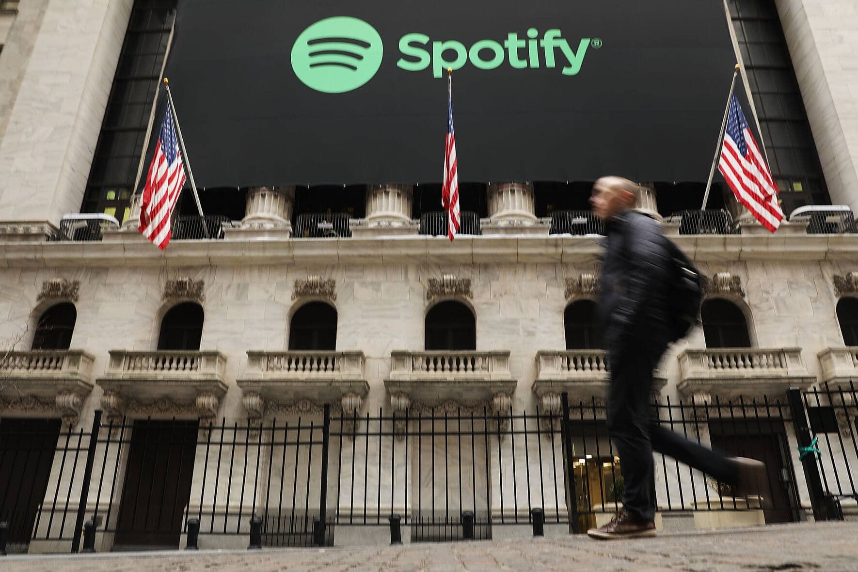 NEW YORK, NY - APRIL 03:  People walk by  the New York Stock Exchange (NYSE) on the morning that the music streaming service Spotify begins trading shares at the NYSE on April 3, 2018 in New York City.  Trading under the symbol SPOT, the Swedish company's losses grew to 1.235 billion euros ($1.507 billion) last year, its largest ever.  (Photo by Spencer Platt/Getty Images)