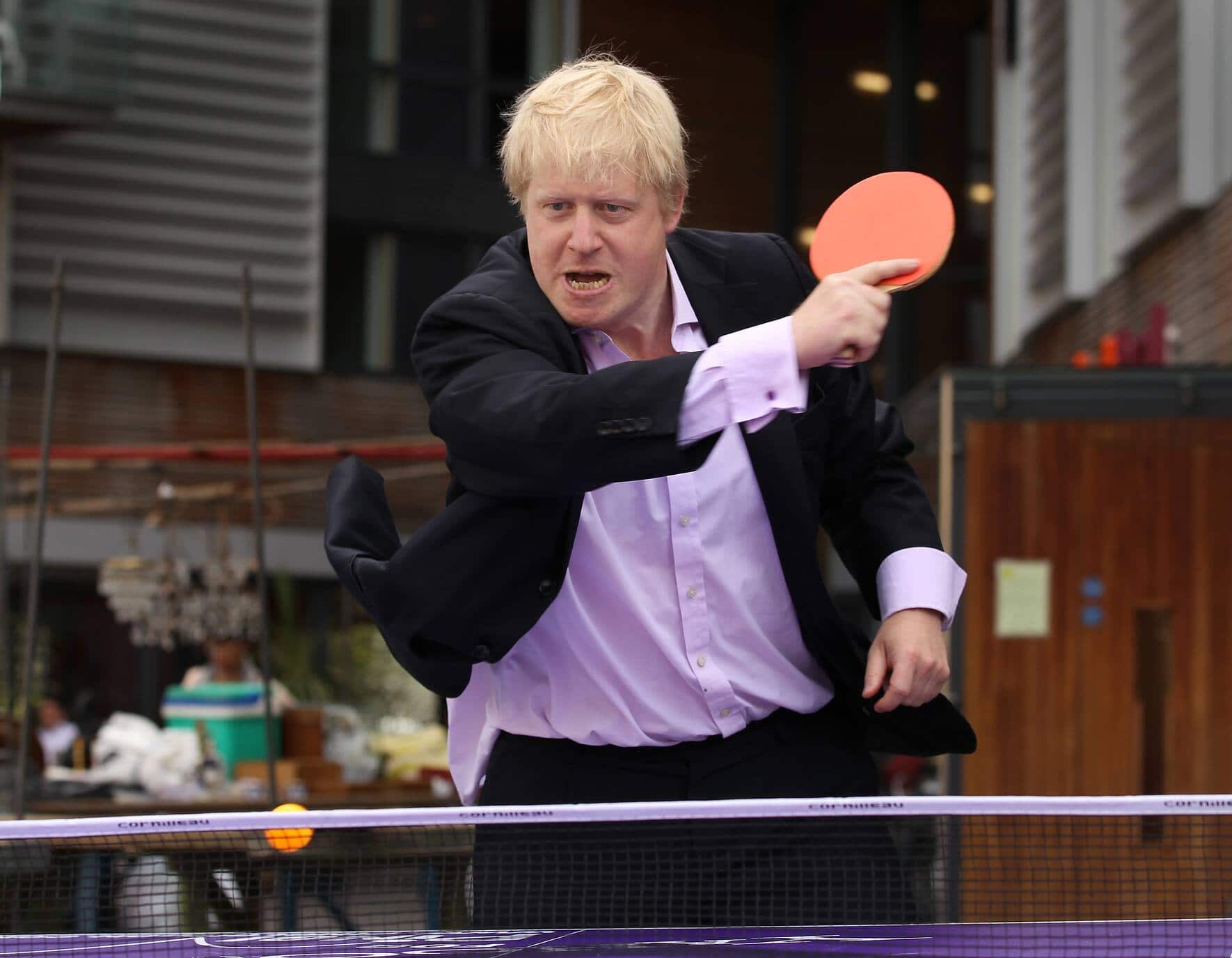 LONDON, ENGLAND - JUNE 25:  London Mayor Boris Johnson plays table tennis with school children at Bermondsey Square  on June 25, 2010 in London, England. The Mayor is promoting a summer initiative 'Playsport London: FreeSport' which is being launched to encourage Londoners to get active.  (Photo by Peter Macdiarmid/Getty Images)