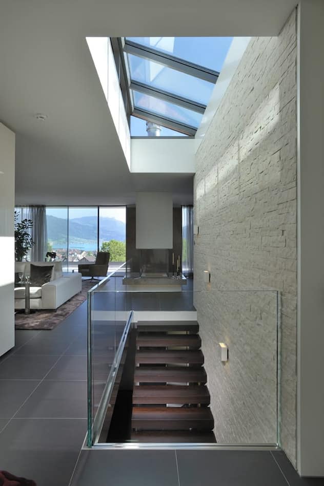 Das viele Glas passt sehr schön zu den dunklen Bodenplatten und den hellen Natursteinmauern.