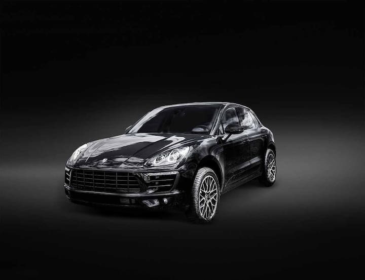 P1KE55 Porsche Macan is parked on a fresh green spring grass