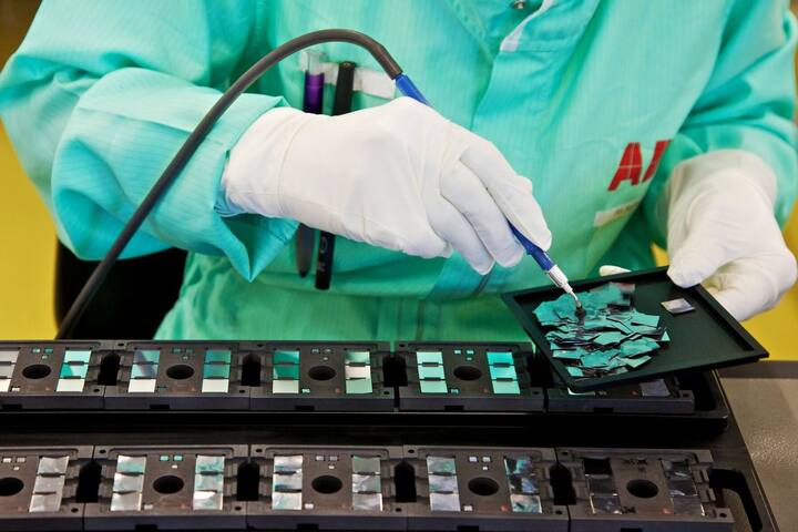 A technician prepares the mounting of ABB-made silicon chips onto HiPak substrates prior to soldering at the ABB AG semi-conductor plant in Lenzburg, Switzerland, on Tuesday, Aug. 30, 2011. ABB AG is the world's largest builder of electricity grids. Photographer: Gianluca Colla/Bloomberg