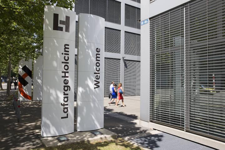 The new logo of LafargeHolcim on panels in front of the head quarters in Zurich, Switzerland, on Wednesday, 15 July 2015. LafargeHolcim today officially launched the new Group around the world and announced key elements of its ambitions for the future. (KEYSTONE/Patrick B. Kraemer)