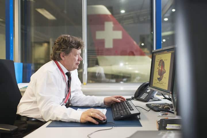 An employee prepares a maintenance at the aircraft maintenance center at Zurich Airport in Kloten in the Canton of Zurich, Switzerland, pictured on July 22, 2014. (KEYSTONE/Christian Beutler)