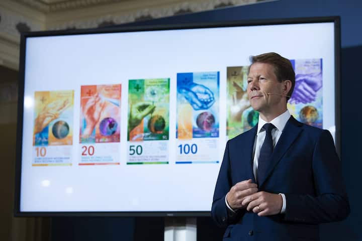 Fritz Zurbruegg, Vice president of the Swiss National Bank, stands beside a screen showing the new series of Swiss banknotes during the presentation of the new Swiss 100 francs banknote in Bern, Switzerland, Tuesday, September 3, 2019. (KEYSTONE/Peter Klaunzer)