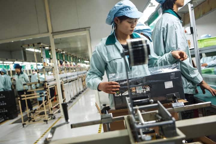 Workers package keyboards at the Logitech International SA factory in Suzhou, Jiangsu Province, China, on Friday, March 2, 2012. Logitech manufactures personal computer input devices including computer mice and keyboards. Photographer: Nelson Ching/Bloomberg