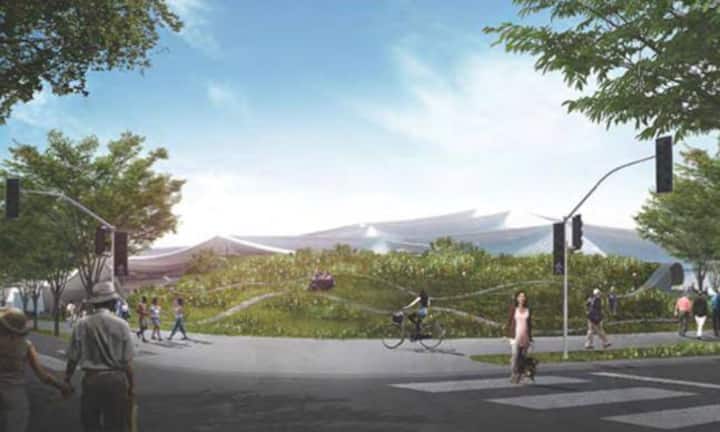 Unter diesem grünen Hügel sind betriebliche Anlagen versteckt, im Hintergrund ist das künftige Hauptgebäude des Google-Campus erkennbar.