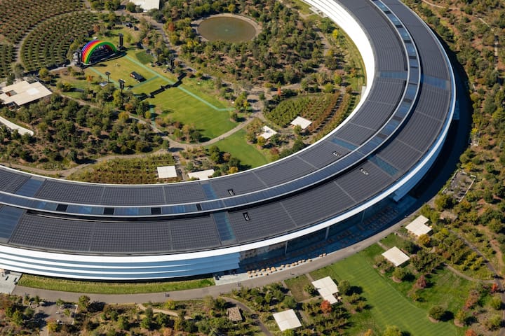 The Apple Park campus stands in this aerial photograph taken above Cupertino, California, U.S., on Wednesday, Oct. 23, 2019. Apple Inc. will report its fourth-quarter results next week, and based on the average analyst price target for the stock, Wall Street is feeling increasingly optimistic about the iPhone maker's prospects. Photographer: Sam Hall/Bloomberg