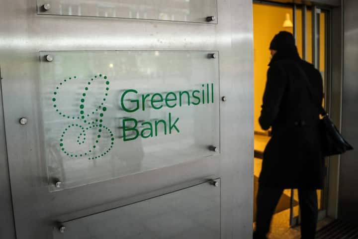 epa09050565 A person enters the Greensill Bank in Bremen, northern Germany, 04 March 2021. The German Federal Financial  Supervisory Authority (BaFin) has banned the bank from regular operations on 03 March due to the threat of over-indebtedness.  EPA/FOCKE STRANGMANN