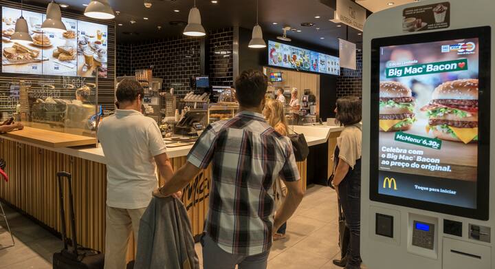 LISBON, PORTUGAL - SEPTEMBER 4: Travelers queue by McDonald's restaurant digital menu boards self-serve kiosks with touch screen in passenger area at Terminal 1 of Humberto Delgado International Airport on September 04, 2018 in Lisbon, Portugal. Portuguese tourist industry has gone through an excellent year in 2018, for the country is rated as very safe by travelers. (Photo by Horacio Villalobos - Corbis/Corbis via Getty Images)