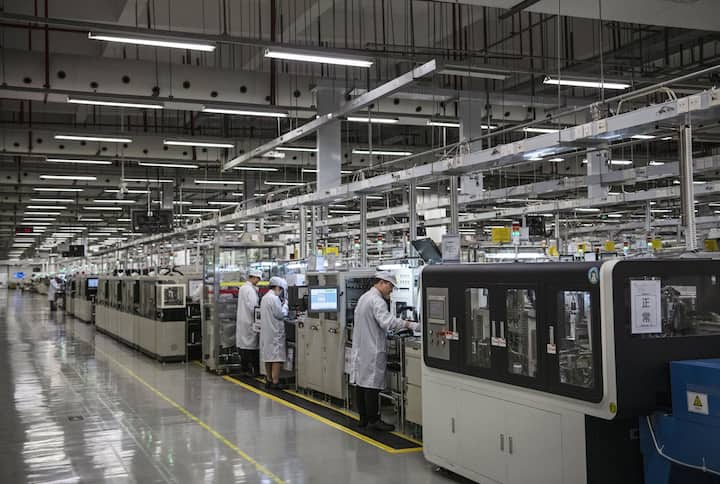Workers are seen on the production line at Huawei's production campus on April 11, 2019 in Dongguan, near Shenzhen, China. 
