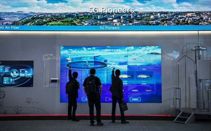 CHINA - APRIL 26: Customers look at a display showing Huawei 5G technology at the company's Bantian campus on April 26, 2019 in Shenzhen, China.