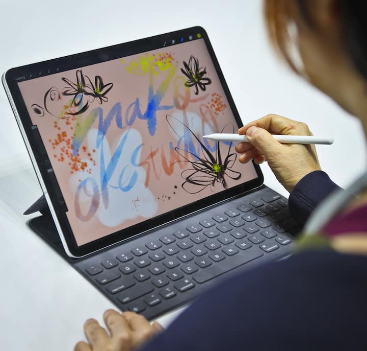 Japanese artist Mako Oke draws on the new iPad Pro using its pencil accessory after an event announcing new products Tuesday Oct. 30, 2018, in the Brooklyn borough of New York. (AP Photo/Bebeto Matthews)