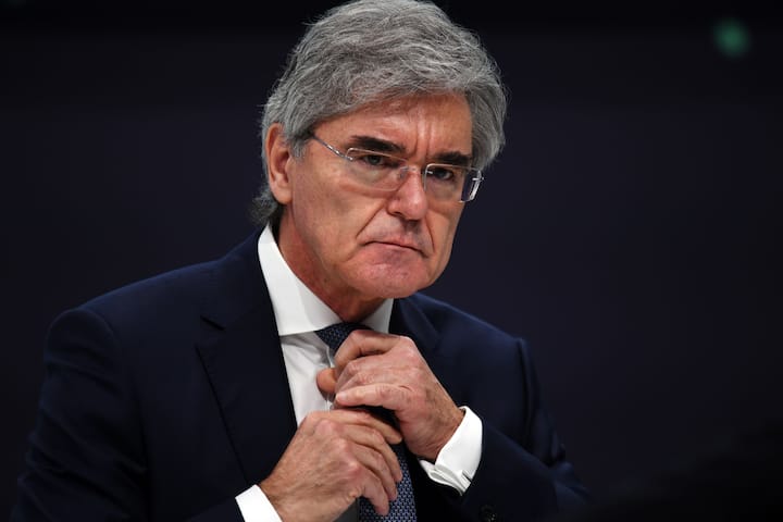 Joe Kaeser, former chief executive officer of Siemens AG, adjusts his tie during the company's full year earnings news conference in Munich, Germany, on Wednesday, Feb. 3, 2021. Siemens AG raised its annual guidance after better-than-expected sales and profit in the first quarter, the latest sign Europes biggest engineering company is benefiting from a strong rebound in China. Photographer: Andreas Gebert/Bloomberg