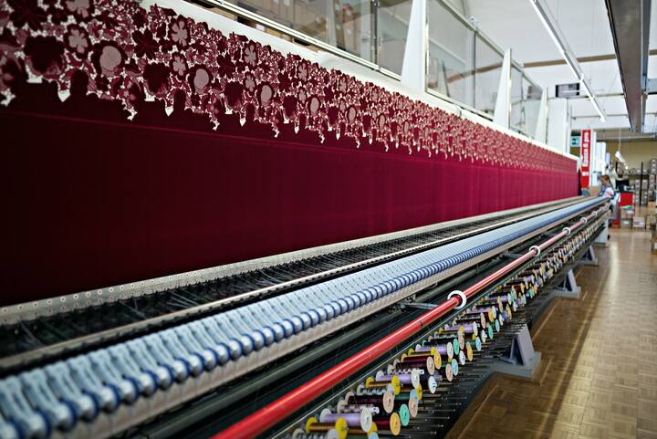 An embroidery machine, manufactured by Saurer AG, embroiders a textile in the stitching hall at the Forster Rohner AG textile production workshop in St Gallen, Switzerland, on Wednesday, May 31, 2017. Forster Rohner, a 113-year-old company in the eastern city of St. Gallen, produces fabric that can cost thousands of dollars per yardincluding material used in the dress that British socialite Pippa Middleton wore at her wedding in May. Photographer: Michele Limina/Bloomberg via Getty Images