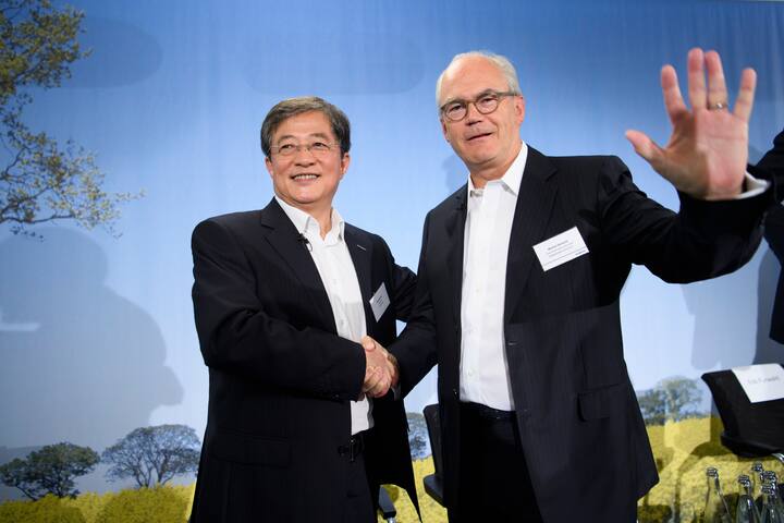 Ren Jianxin, left, chairman of ChemChina and futur  Chairman of Syngenta shakes hand with Michel Demare, right, futur vice-chairman and lead independent director of Syngenta during a press conference of Syngenta after its acquisition by ChemChina, in Basel, Tuesday, June 27, 2017. The China National Chemical Corporation, or &#x201a;"ChemChina" has acquired the worlds biggest producer of agricultural chemicals, the Swiss agribusiness company Syngenta AG. (KEYSTONE/Laurent Gillieron)