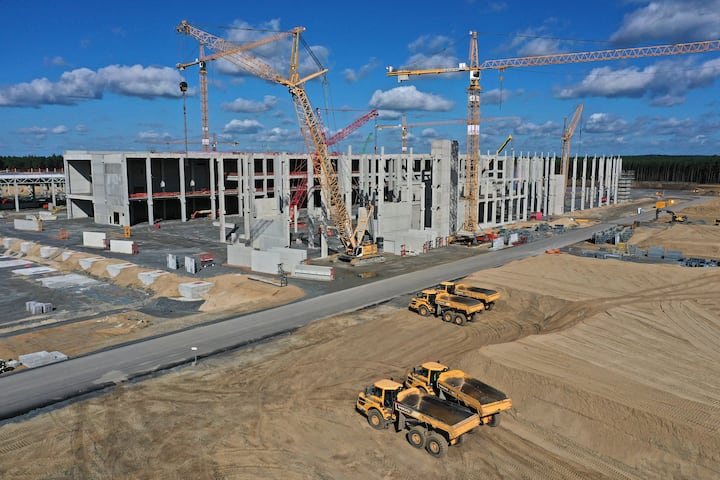 GRUENHEIDE, GERMANY - SEPTEMBER 06: In this aerial view from a drone, cranes stand among the future paint shop (L) and energy unit at the construction site of the new Tesla Gigafactory near Berlin on September 06, 2020 near Gruenheide, Germany. Tesla is planning to begin electric car production at the site by the summer of 2021 with 12,000 employees and an output of at least 100,000 cars annually.  (Photo by Sean Gallup/Getty Images)