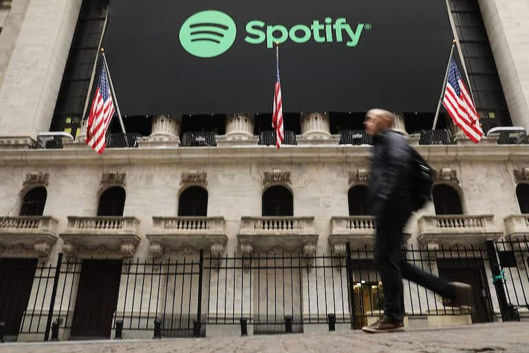 NEW YORK, NY - APRIL 03:  People walk by  the New York Stock Exchange (NYSE) on the morning that the music streaming service Spotify begins trading shares at the NYSE on April 3, 2018 in New York City.  Trading under the symbol SPOT, the Swedish company's losses grew to 1.235 billion euros ($1.507 billion) last year, its largest ever.  (Photo by Spencer Platt/Getty Images)