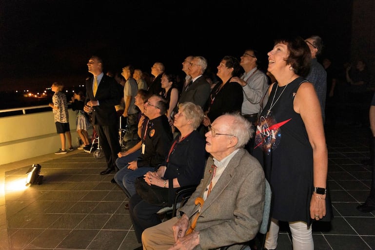 Dr. Eugene Parker (seated in the foreground), a pioneer in heliophysics and S. Chandrasekhar distinguished service professor emeritus for the Department of Astronomy and Astrophysics at the University of Chicago, watches the launch of NASA's Parker Solar Probe. This is the first agency mission named for a living person. Standing behind Parker is Nicky Fox, Parker Solar Probe project scientist at Johns Hopkins Applied Physics Laboratory.